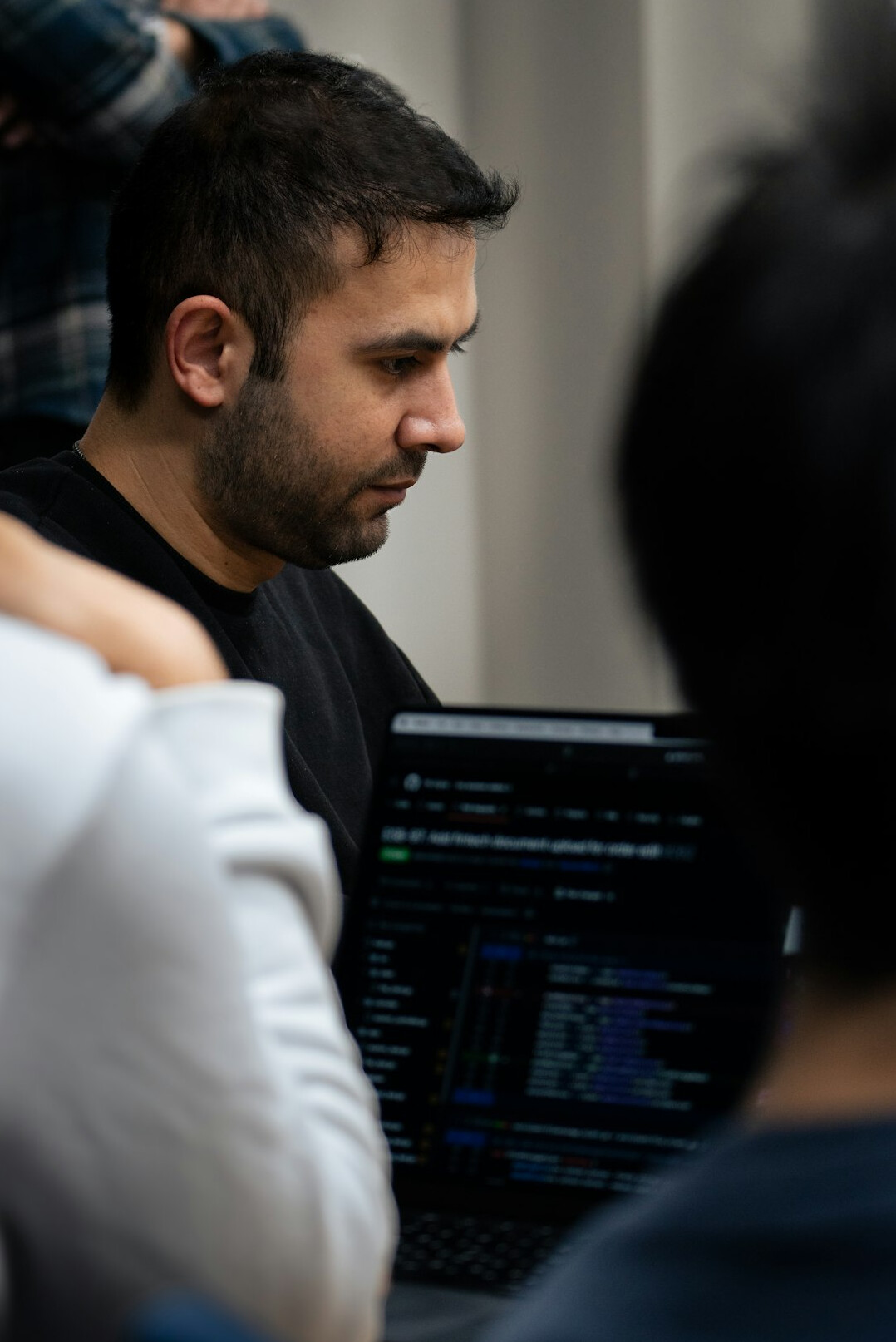 young programmer coding on laptop