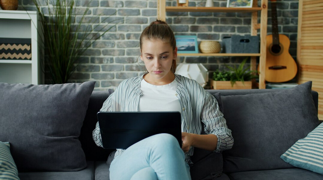 young woman learning coding at home